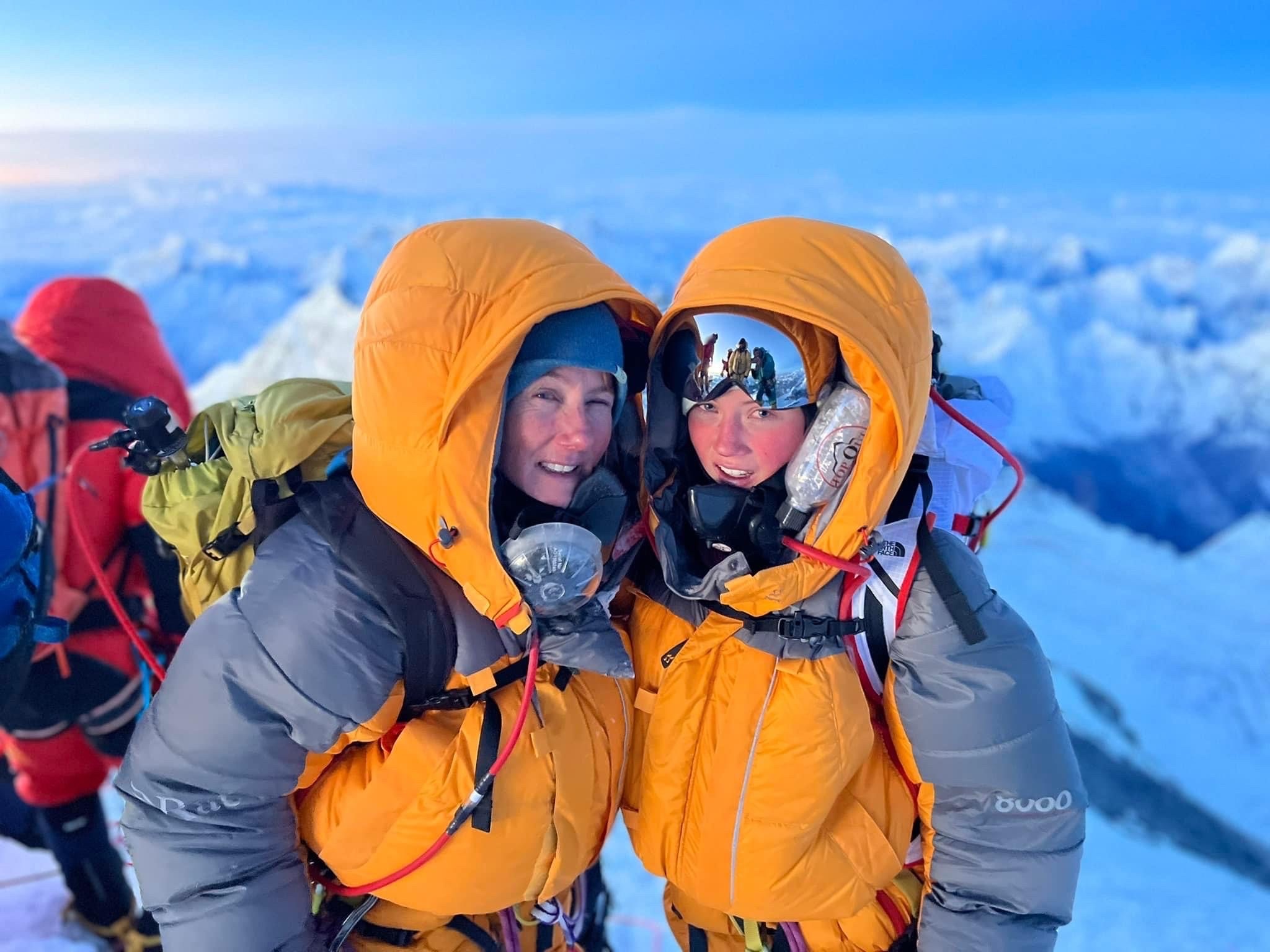 Gabby and her mother pose smiling on the summit of Mount Everest.